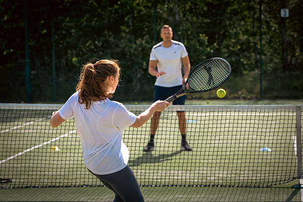Man and woman playing tennis