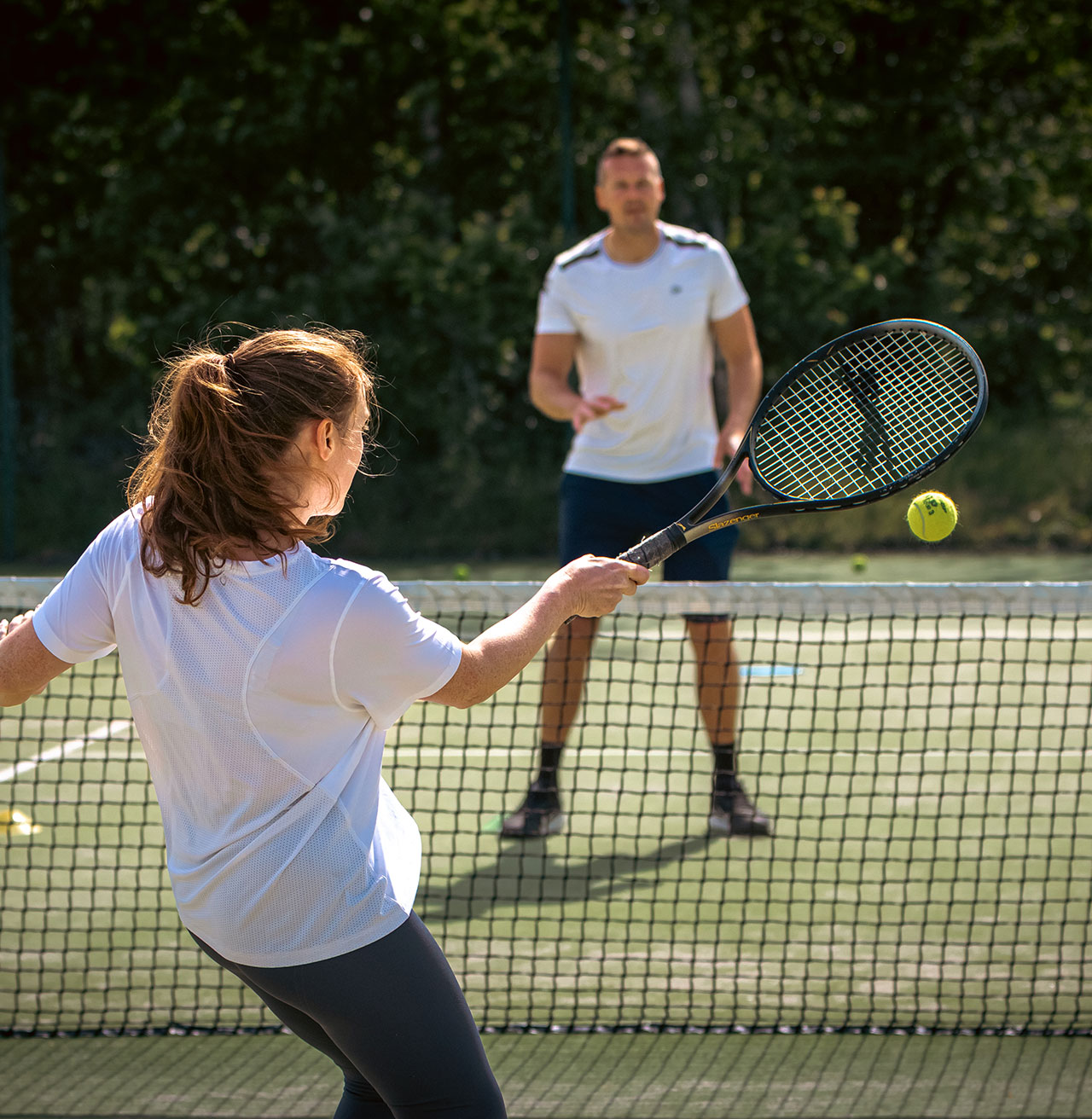 Man and woman playing tennis