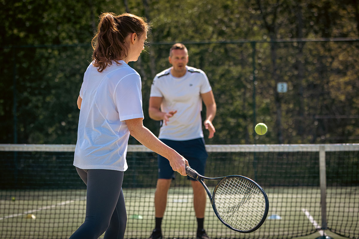 Man and woman playing tennis